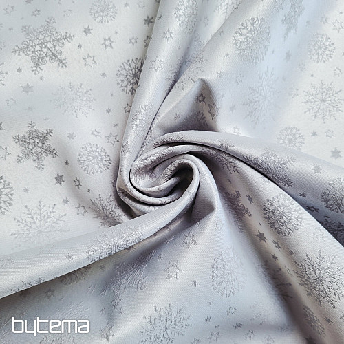 Tela decorativa lisa con estampado de copos de color gris.