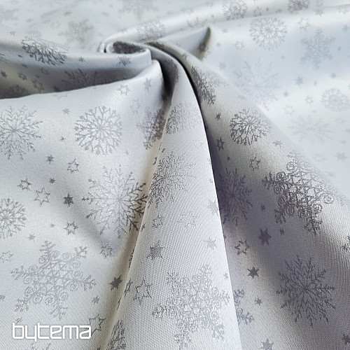 Tela decorativa lisa con estampado de copos de color gris.