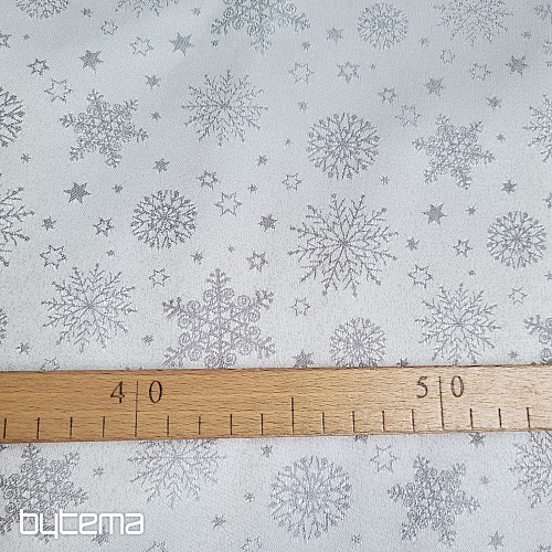 Tela decorativa lisa con estampado de copos de color gris.