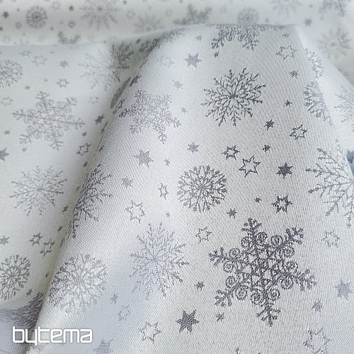 Tela decorativa lisa con estampado de copos de color gris.