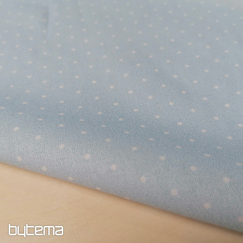 Tela de algodón con lunares azules.